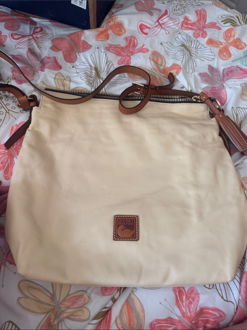 Dooney & Bourke Cream Leather Shoulder Bag with Tan Trim and Tassel